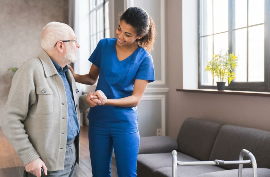 A senior receiving support from a nurse at a memory care community.