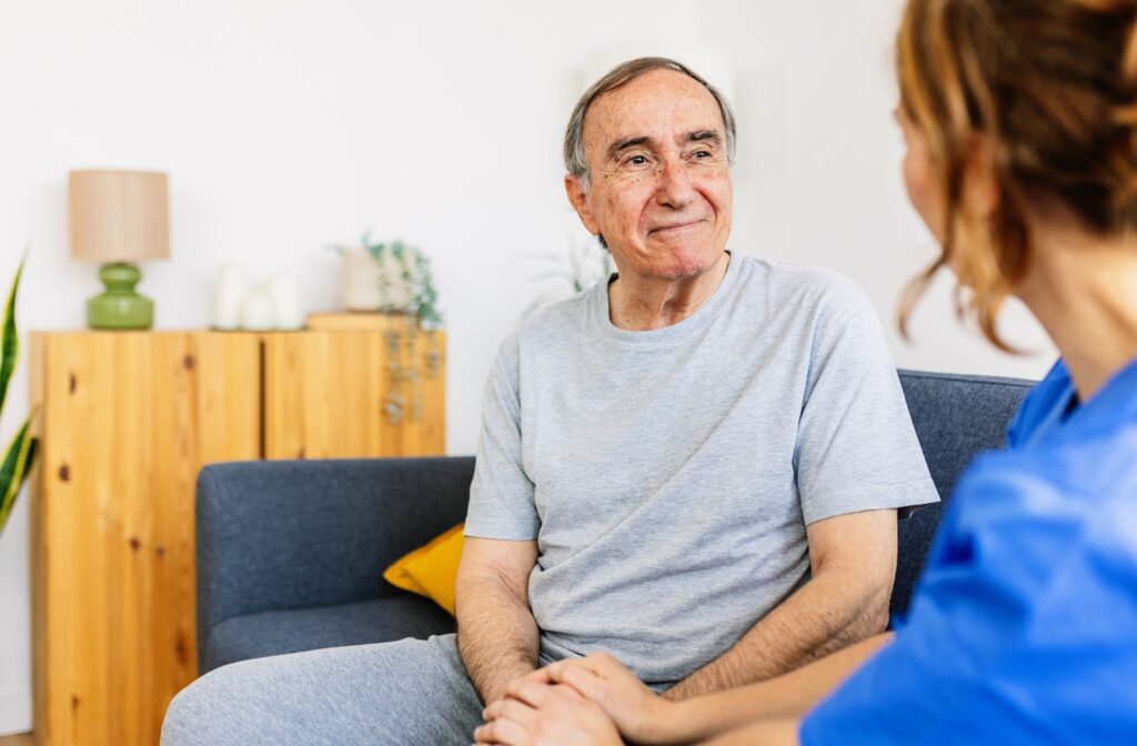 Someone talks kindly to an older adult about his living situation.